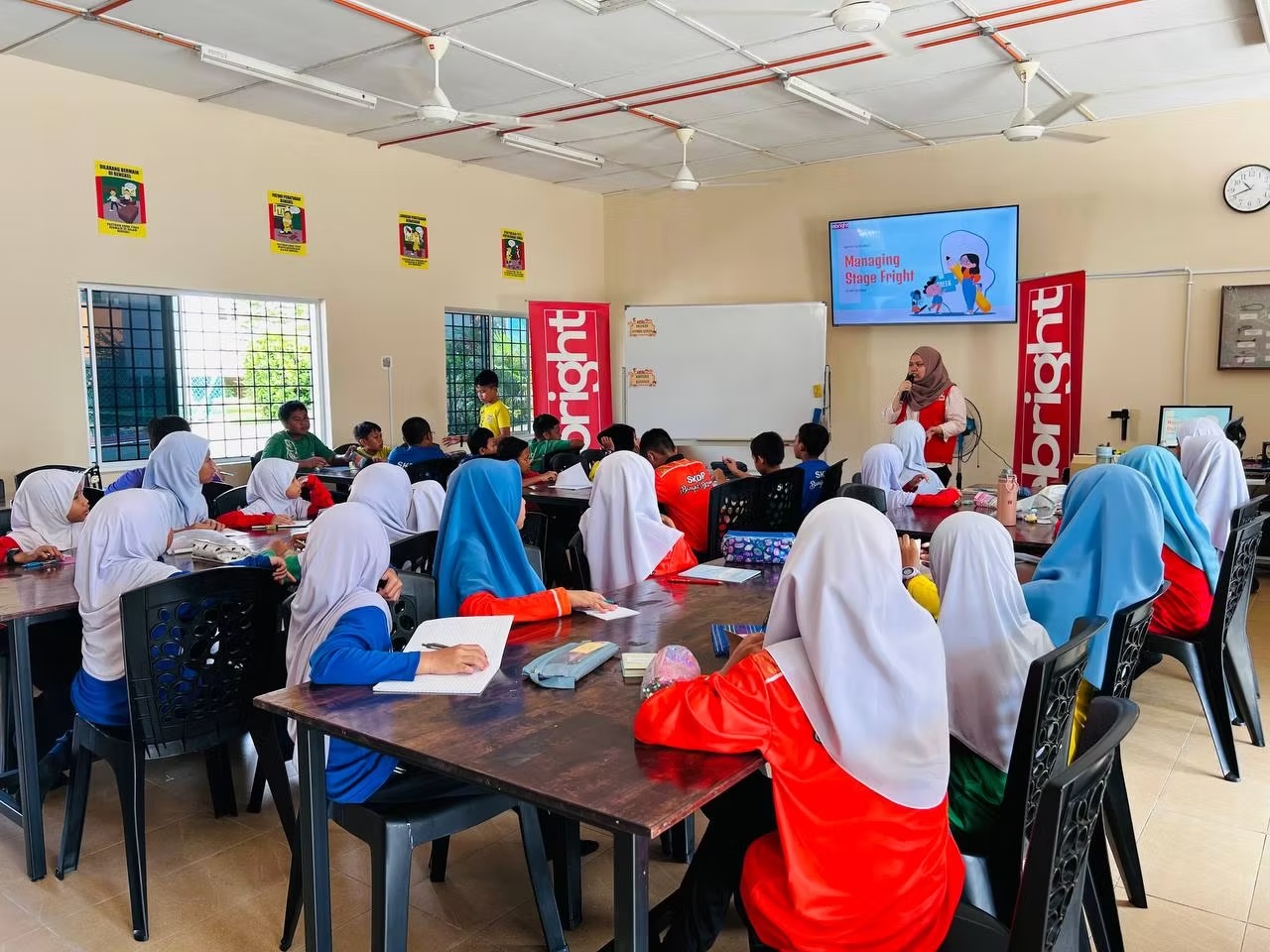 Facilitator speaking with students at school